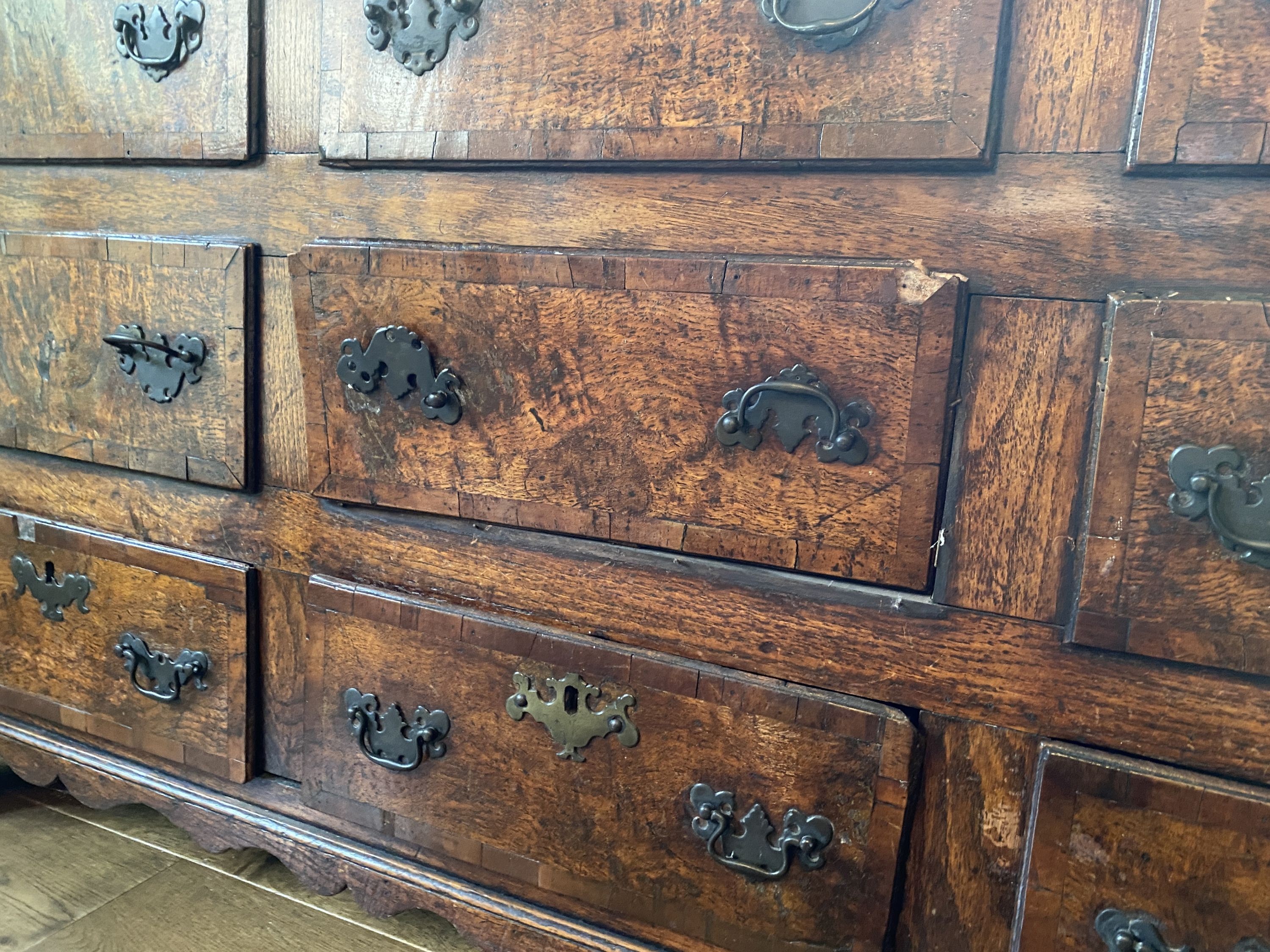 A mid 18th century crossbanded oak mule chest, with rising top and six dummy drawers over three base drawers, on ogee feet, width 155cm depth 57cm height 88cm